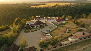 A residential area with multiple houses, a large driveway, and a playground. - Regency Mount Kenya Hotel (Ethi)