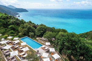 Outdoor pool, an infinity pool, pool umbrellas, sun loungers