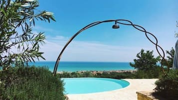 Piscine extérieure, parasols de plage, chaises longues