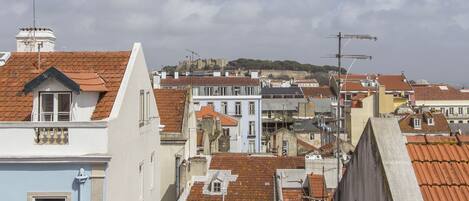 A densely packed urban area with buildings featuring red-tiled roofs and a variety of architectural styles.