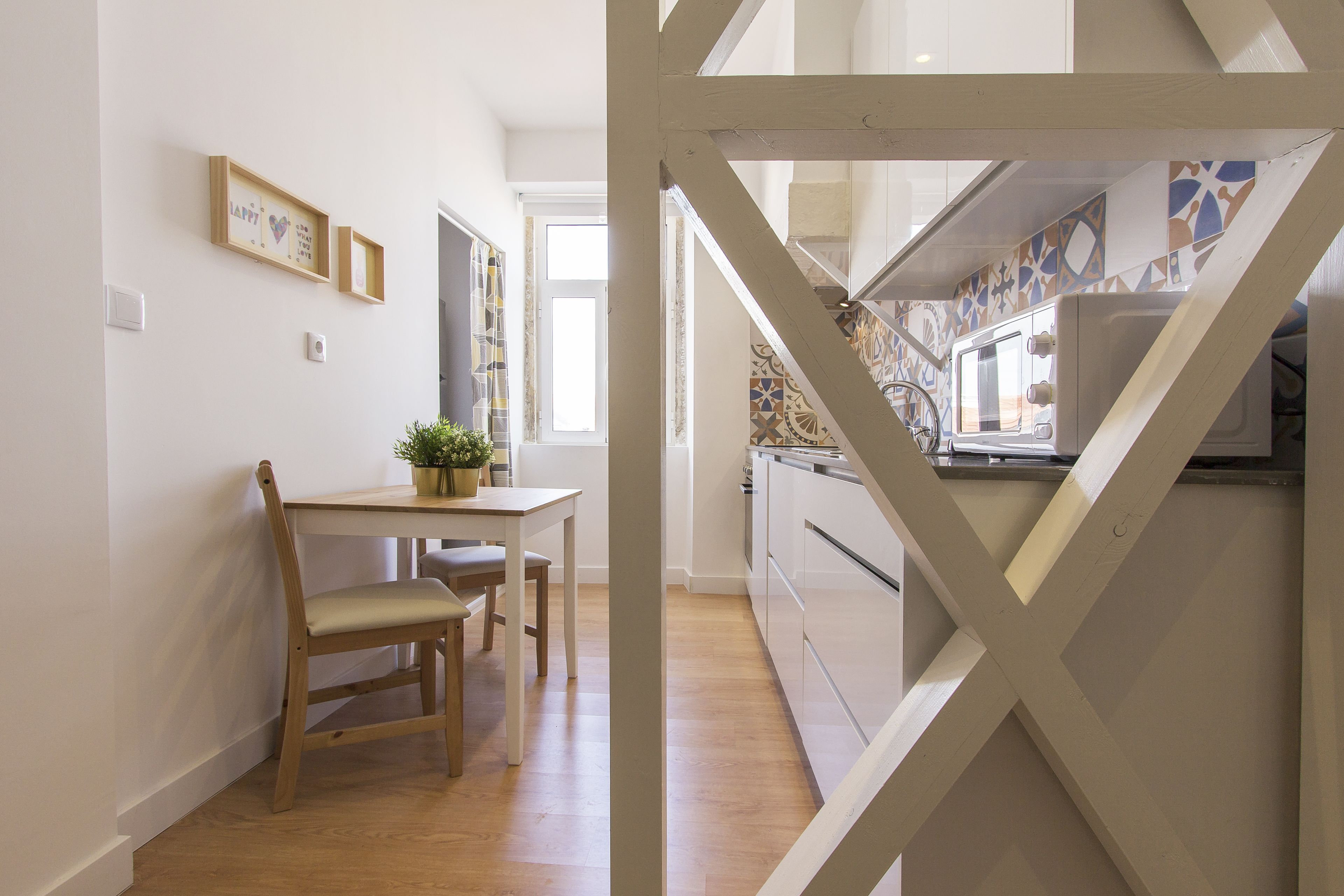 A modern kitchen with a built-in oven and a window overlooking the garden.