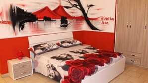 A bedroom with a bed, nightstand, and wardrobe. - B&B La Torretta di Chiaia (Naples)