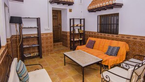 Una sala de estar acogedora con un sofá, una mesa y estanterías.