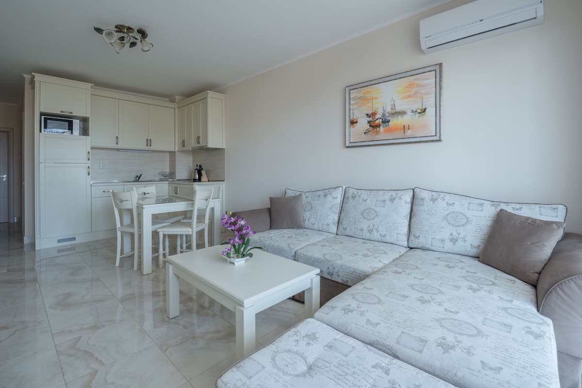 Deluxe Apartment, 2 Bedrooms, Poolside | Living area | Flat-screen TV