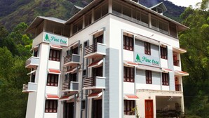 A multi-story hotel with balconies and a sign reading "Pine tree Munnar". - Pine Tree Munnar (Devikolam)