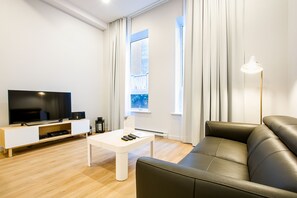 Apartment, 1 Bedroom with Bunk Beds (LC309) | Living area | 35-inch flat-screen TV with cable channels, TV - Les Lofts Charest - By Les Lofts Vieux-Quebec (Québec City)