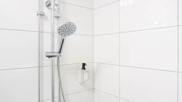 A modern shower with a handheld showerhead and a fixed overhead showerhead, mounted on a chrome pipe.