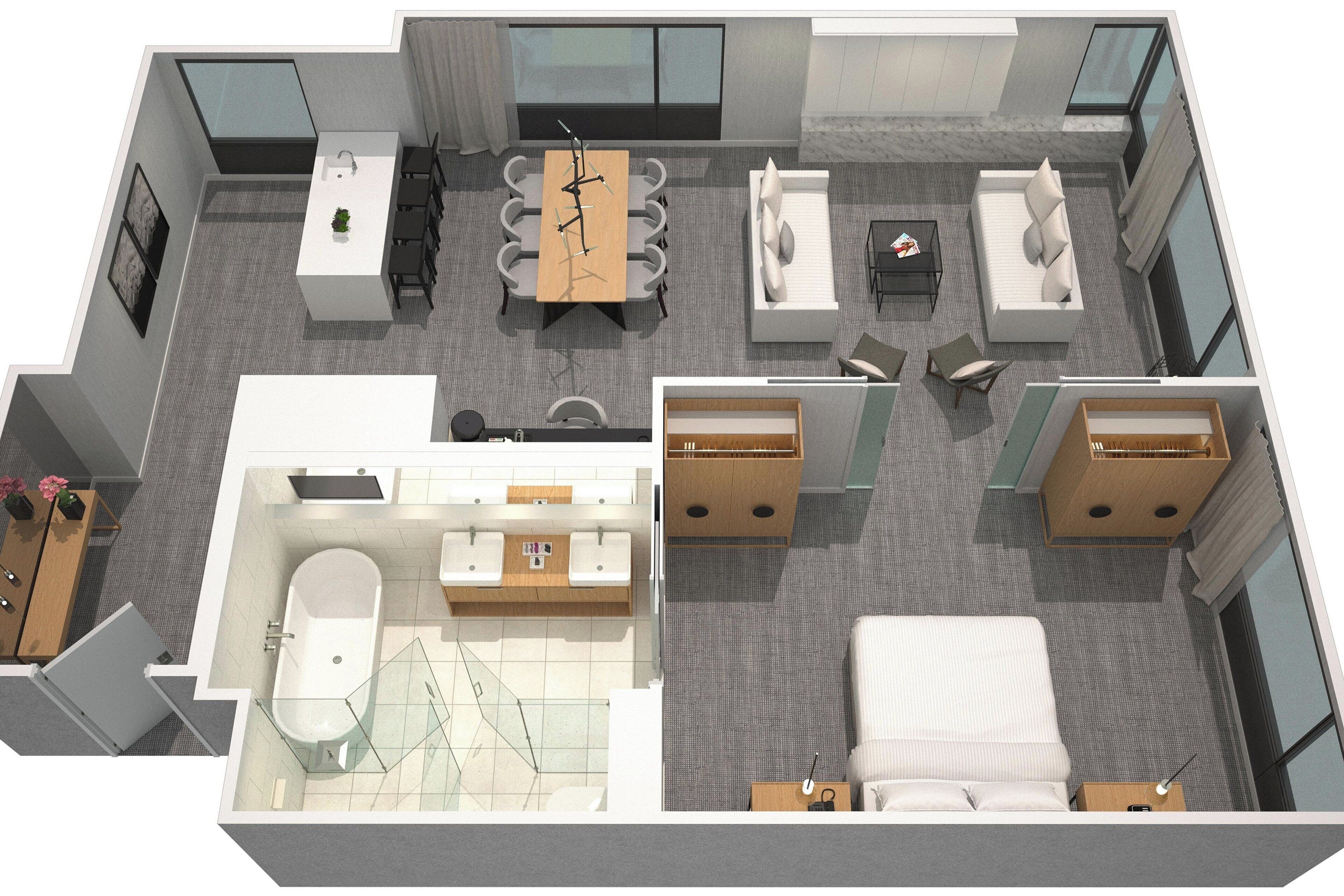 Distribución de una habitación de hotel con baño, zona de comedor, sofá, cama y una pequeña mesa.