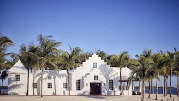 A white building with a symmetrical facade, multiple windows, and a central entrance.