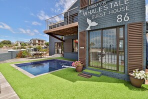 A modern building with a sign reading "The Hermanus Whale's Tale Guest House 86." - The Whale's Tale Guesthouse (Hermanus)