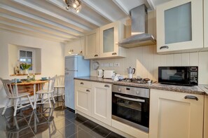 A kitchen with white cabinets, a blue refrigerator, a gas stove, an oven, and a microwave. - 2 Bed in West Down (oc-julyco) (West Down)
