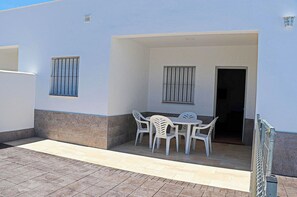 Enjoy outdoor dining or relaxation on the patio with a table and chairs.