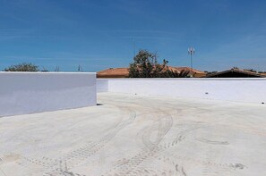 Enjoy panoramic views from this rooftop space with a clear blue sky above.