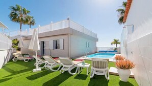 A modern villa with a swimming pool, white lounge chairs, and artificial grass. - .."Beautiful luxury spacious 4 bed villa Costa Adeje with a heating pool".. (COSTA ADEJE)