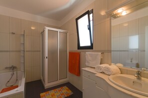 Bathtub, hair dryer, bidet, towels