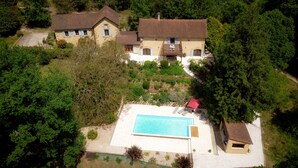 An aerial view of a property with two main buildings, a swimming pool, and surrounding greenery. - Wonderful 4 bedroom, 4 bath Perigordine House, heated pool, 5 acres, Sarlat 6km (Saint-André-D'allas)