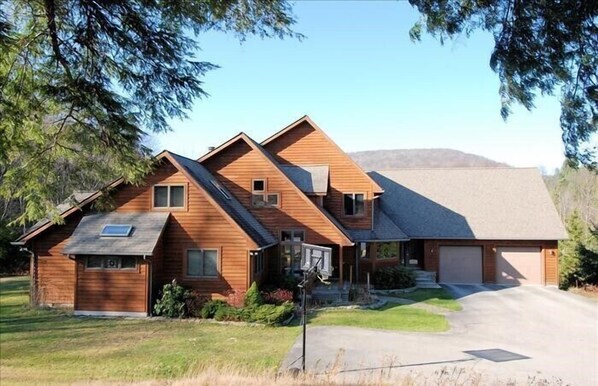 A modern two-story house with a sloped roof, a garage, and a well-maintained lawn. - ML03-Lakefront Retreat, Hot Tub, Pets Ok! New A/C! (Davis)