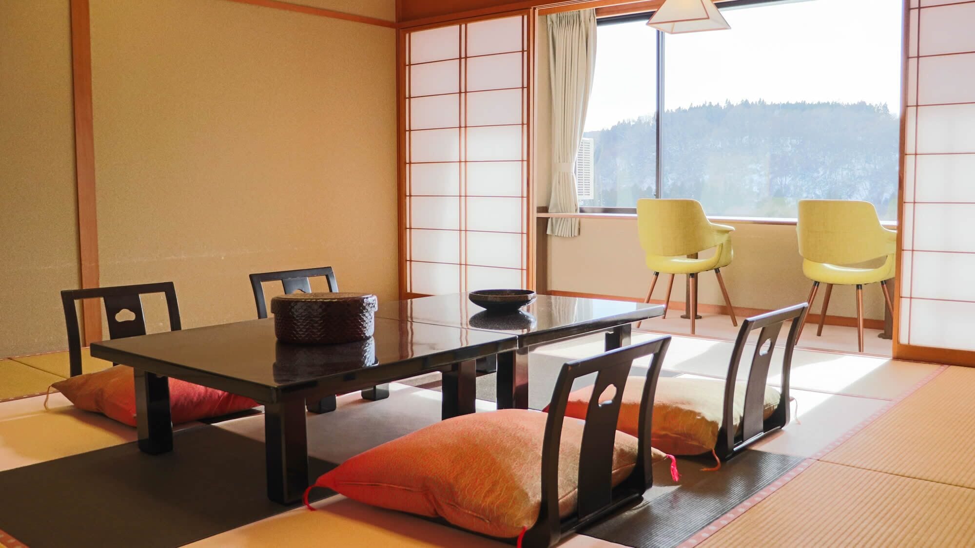 A traditional Japanese room with tatami flooring, a low table, and shoji screens.