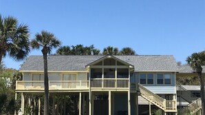 A two-story house with a balcony and a covered porch.