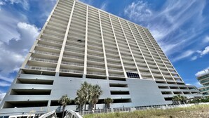 A high-rise building with multiple balconies and a modern architectural design. - Ocean Reef Beach-Front, Luxury, Condo with Awesome Balcony, Highly Rated! (Panama City Beach)