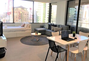 Deluxe Apartment | Living room | 42-inch flat-screen TV with digital channels, TV, Netflix - ReadySet Apartments at Upper West Side (Melbourne)