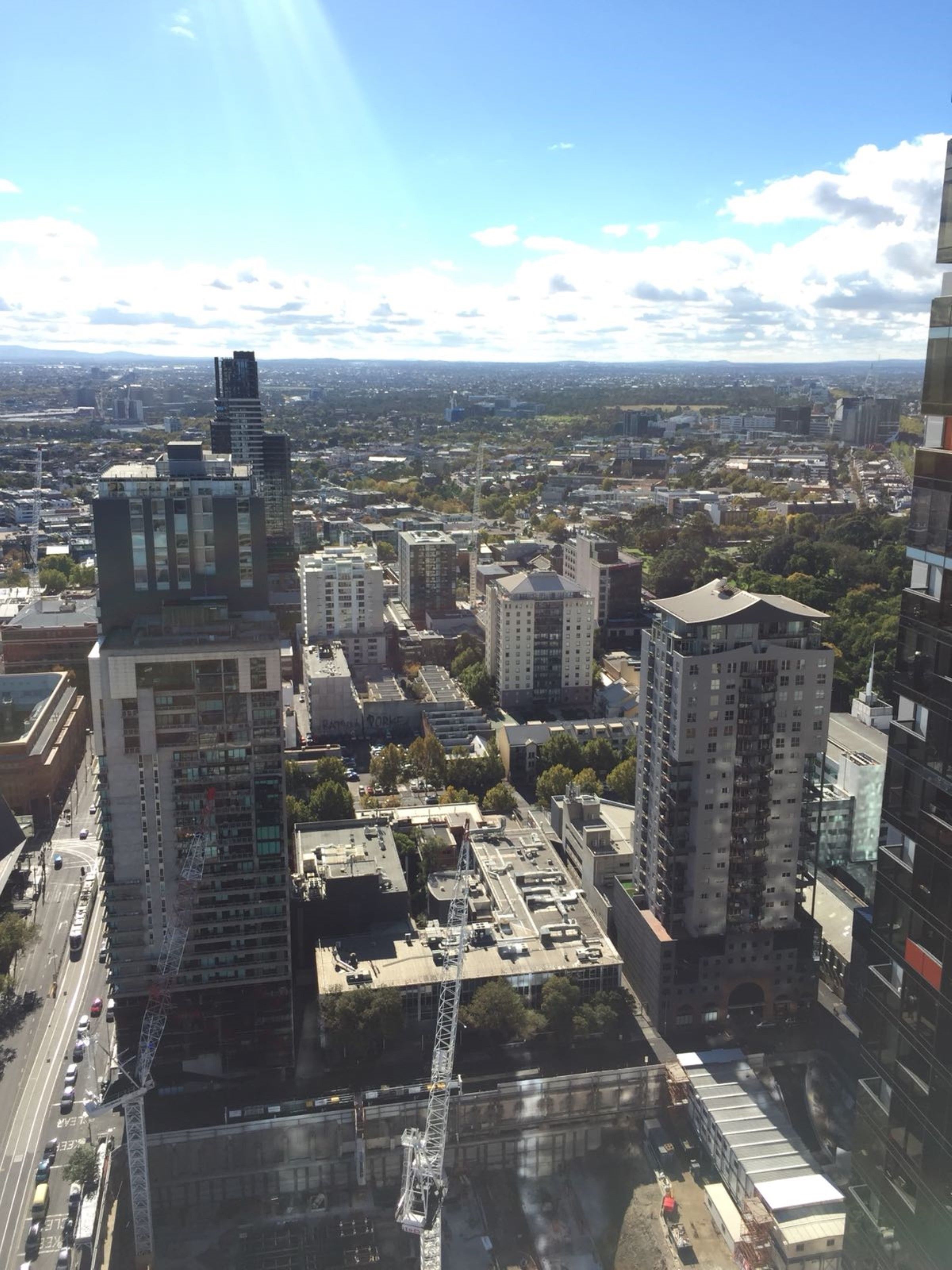 A cityscape with multiple high-rise buildings, including a distinctive tower with a unique design.