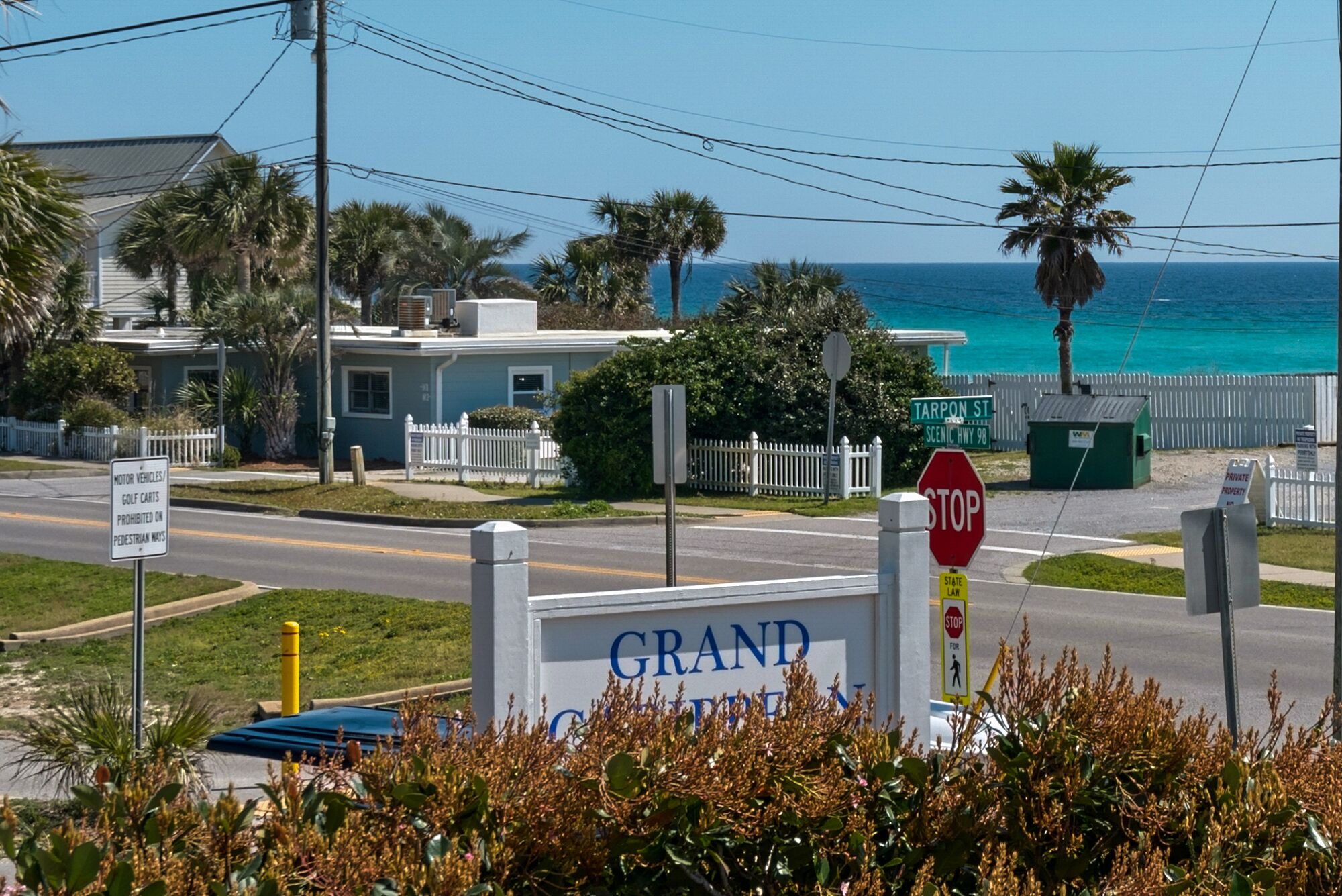 A sign for 'Grand Ocean' with a stop sign nearby.