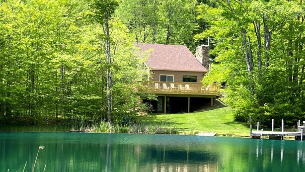 A house with a deck overlooking a lake, surrounded by trees. - SS12-Bass, Blue Gill, and Catfish Pond! Hot Tub! Dolly Sods Access! (Davis)