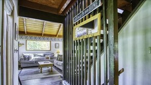 A hallway with a wooden ceiling, a sofa, a coffee table, and a sign that reads "Welcome to our HOME". - SS12-Bass, Blue Gill, and Catfish Pond! Hot Tub! Dolly Sods Access! (Davis)