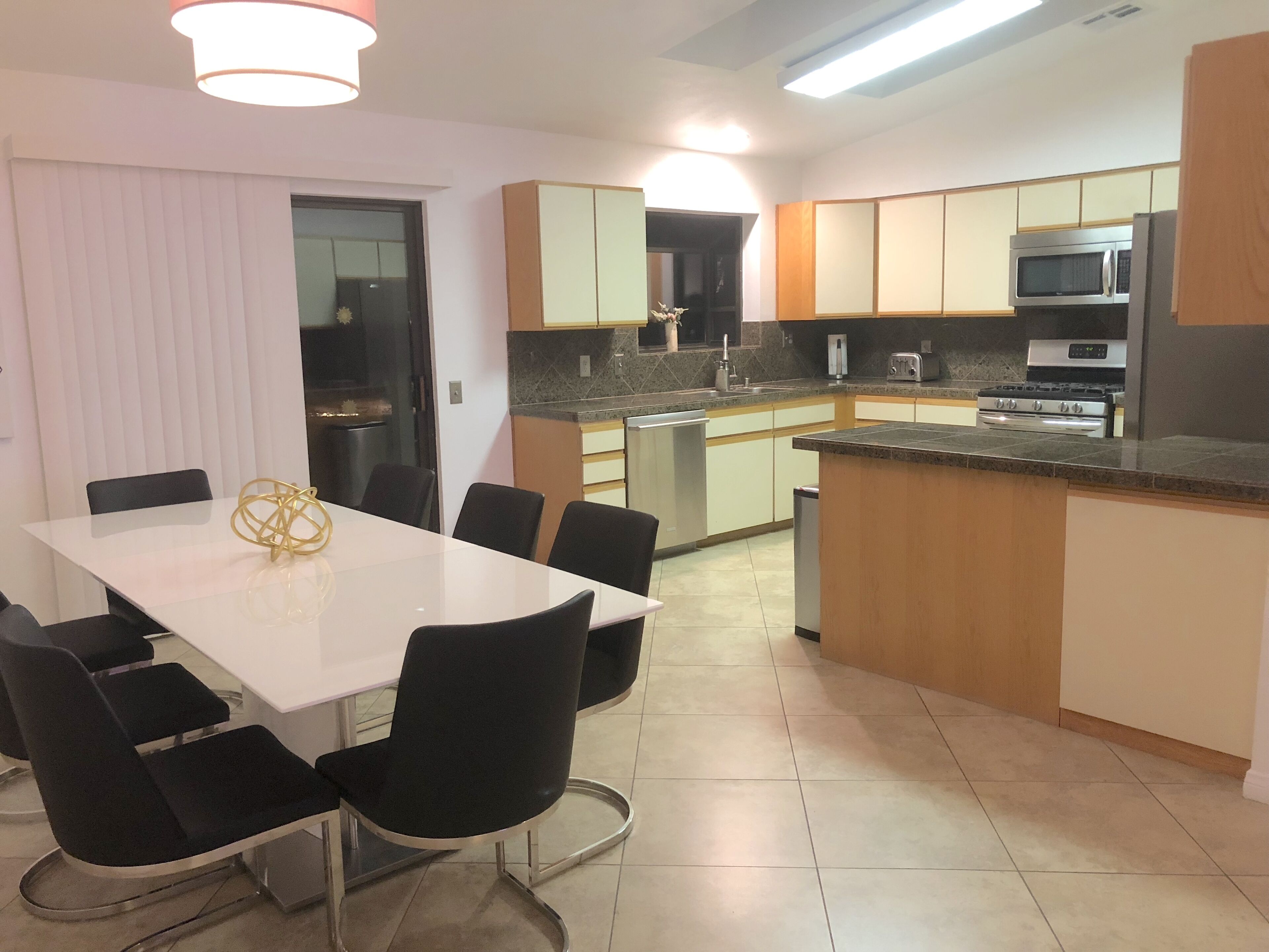 A modern kitchen with a dining area.