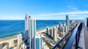 A coastal cityscape with high-rise buildings, a beach, and a clear blue sky. - Sealuxe Seaview Suites - Central Surfers Paradise (Surfers Paradise)