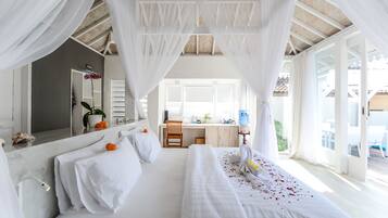 A hotel room with a large bed, a desk, and a view of the outdoors.