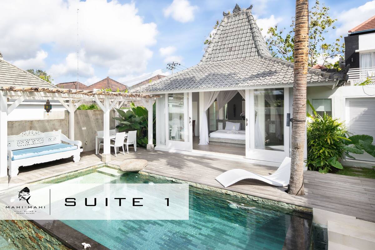 A modern villa with a swimming pool, a covered patio, and a traditional tiled roof.