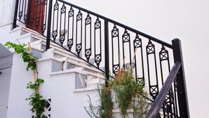 A staircase with black metal railings, white walls, and red shutters. - Naxos "Asty" walking distance to everything! (Naxos)