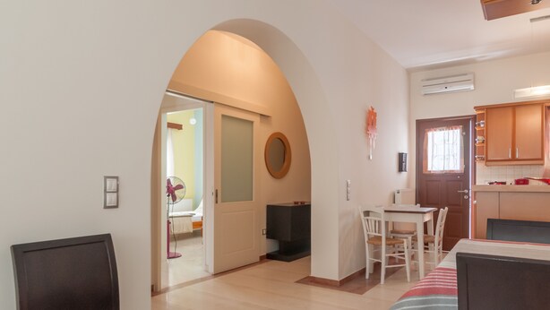 A modern living room with a dining area, a kitchen, and an open-plan layout. - Naxos "Asty" walking distance to everything! (Naxos)