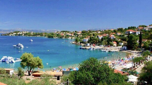 A coastal town with a marina, beach, and residential buildings. - Villa Sol - private heated pool & 30m from the sea (Necujam)