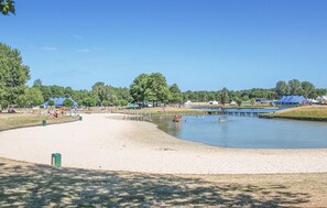 Enjoy serene lakeside views and relax on the sandy beach.