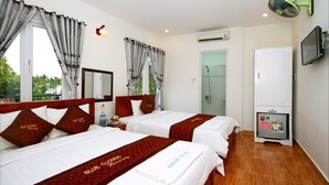 A hotel room with two beds, a TV, a minibar, and a shower area. - Blue Clouds Homestay (Da Nang)