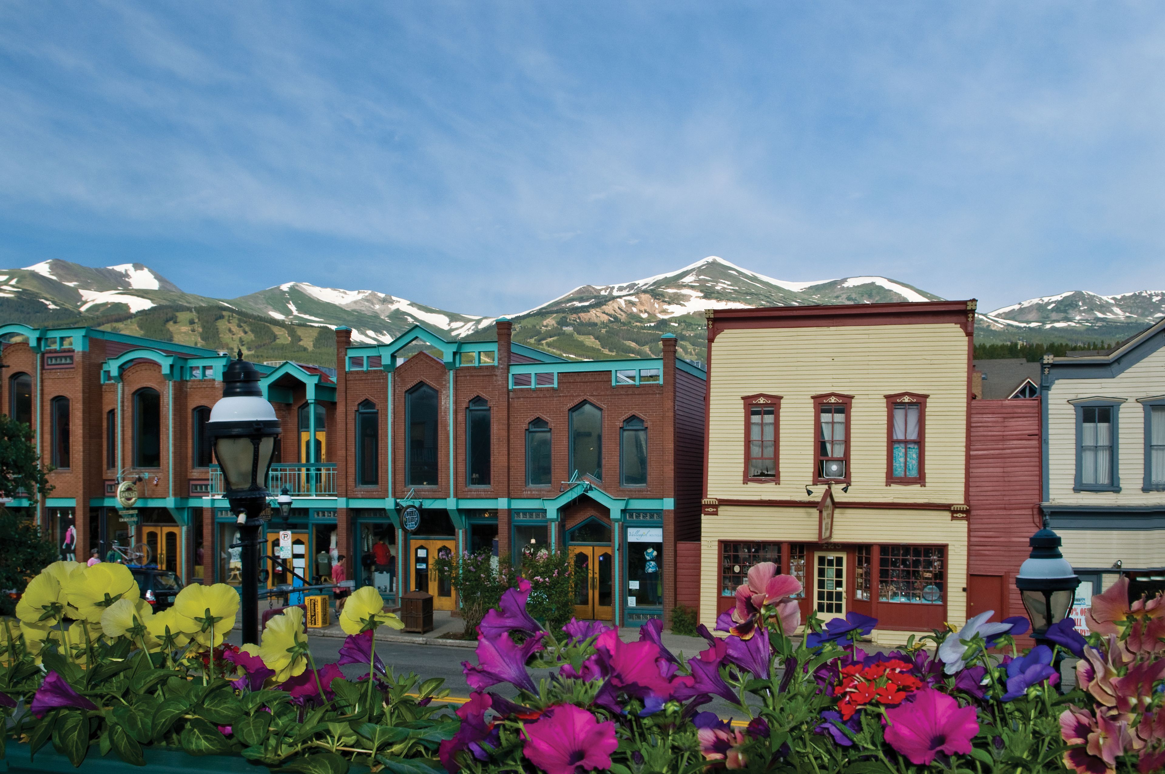 A row of colorful buildings with a mountain backdrop.