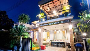 A two-story building with a sign reading "Timeless pool villa" and a visible phone number. - Timeless Pool Villa Huahin (Hua Hin)