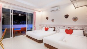 A hotel room with two beds, a sliding glass door to a balcony, and heart-shaped wall decorations. - Timeless Pool Villa Huahin (Hua Hin)