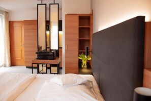 Hypo-allergenic bedding, desk, laptop workspace, blackout drapes