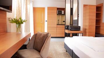 Hypo-allergenic bedding, desk, laptop workspace, blackout drapes