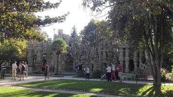 A park with a stone structure, pathways, and trees.