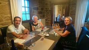 A stone-walled room with a table set for four people. - La Meridienne des Collines (La Motte-de-Galaure)