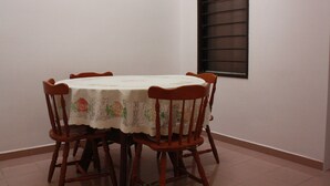 A dining table with a floral tablecloth and six wooden chairs. - 34 First Island (George Town)