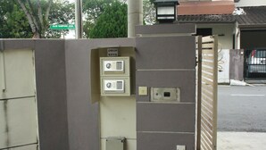 A gated entrance with a drop box and a keypad lock. - 02 First Island (George Town)