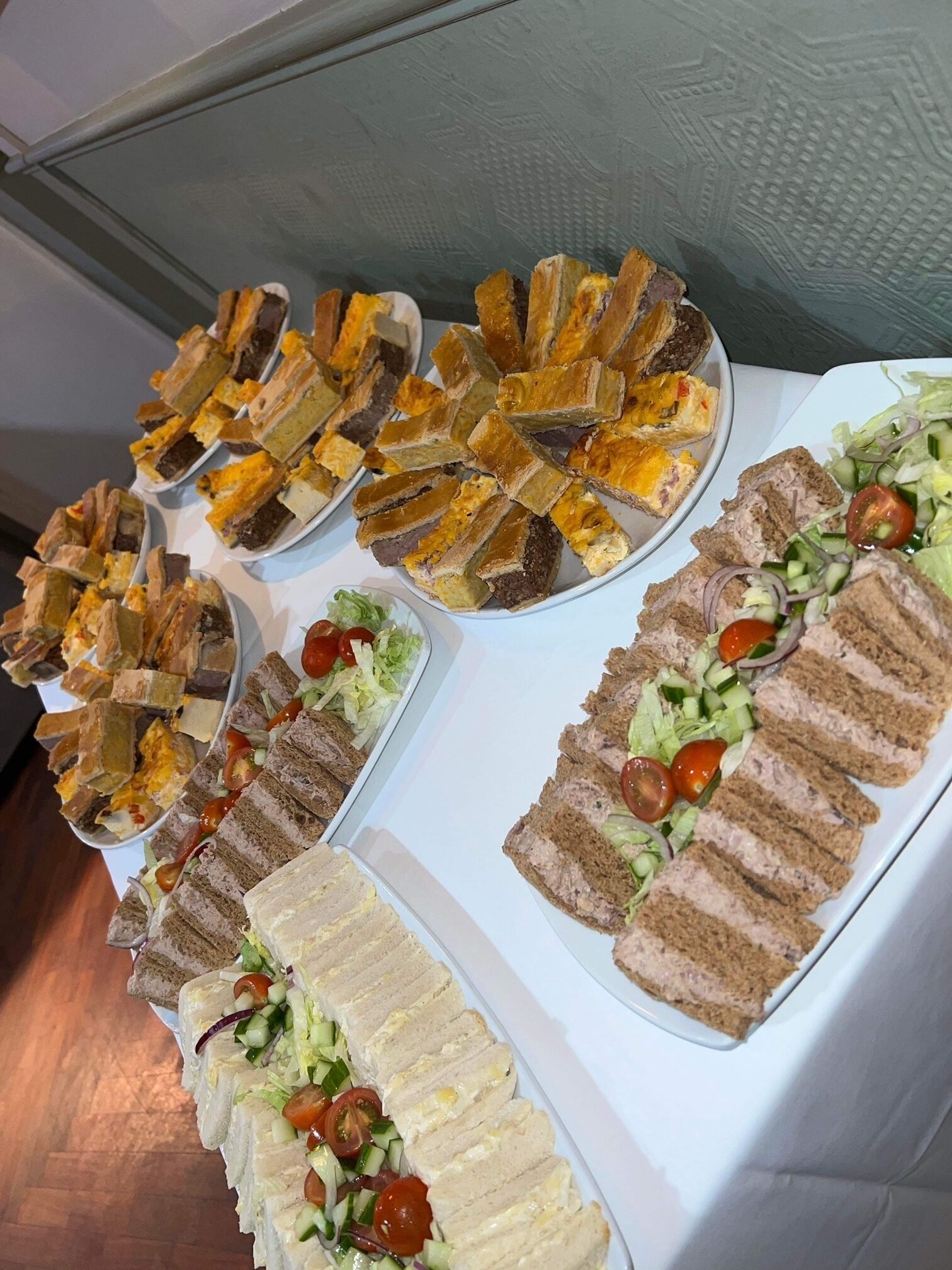 Una mesa de buffet con diferentes sándwiches y ensaladas.
