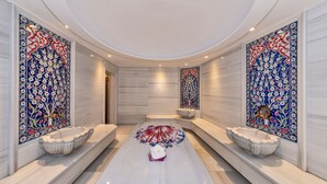 A hallway with a central marble bench, two wall-mounted sinks, and decorative tiles. - Piya Sport Hotel (Istanbul)