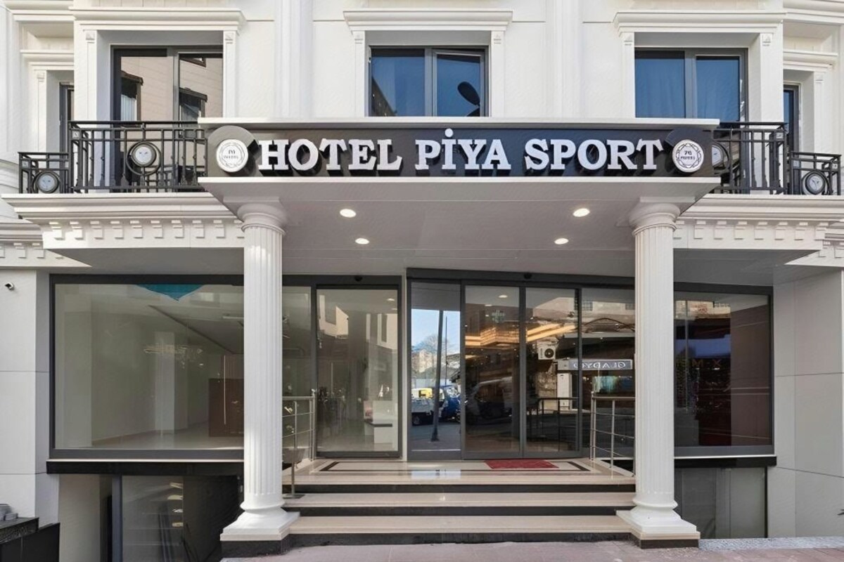 A hotel entrance with a sign reading 'HOTEL PIYA SPORT,' large glass doors, and a balcony with railings.